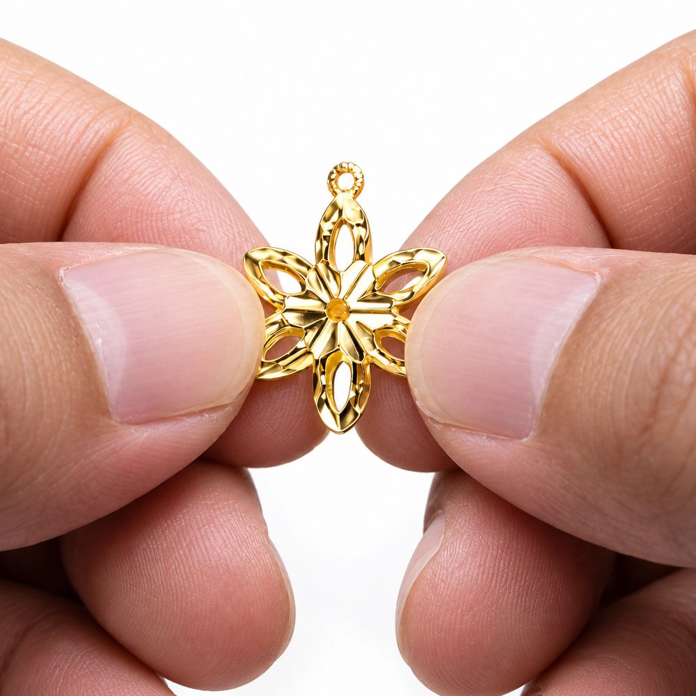 Gold flower pendant held between fingers